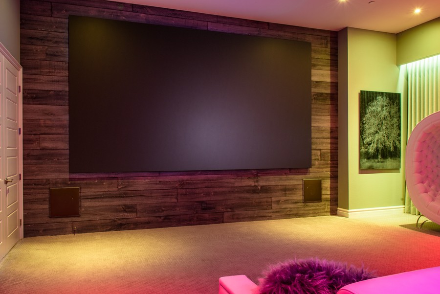 a home theater with a  widescreen TV and built-in speakers