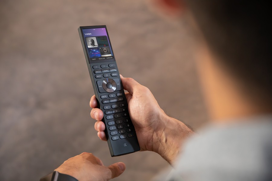 Hand holding the Control4 Halo smart home remote. 