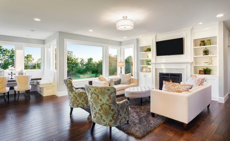 An open living space with a seating area and ceiling lighting fixtures.