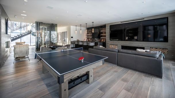 Modern game room with a table tennis and a video wall in grey tones